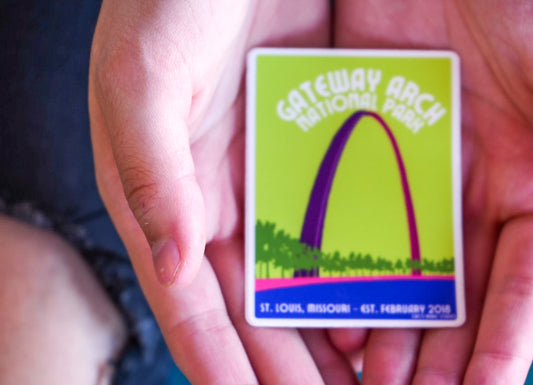 Hand holding a Gateway Arch National Park sticker